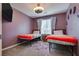 Bedroom with twin beds, patterned rug, and large window at 8736 Summoners Ct, Las Vegas, NV 89139