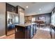 Kitchen showcasing stainless steel refrigerator, kitchen island, and an open floor plan at 8736 Summoners Ct, Las Vegas, NV 89139