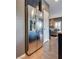 Close up of the kitchen featuring stainless steel refrigerator near entry door at 8736 Summoners Ct, Las Vegas, NV 89139