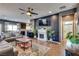 Comfortable living room featuring a fireplace, tv, and hardwood floors throughout at 8736 Summoners Ct, Las Vegas, NV 89139