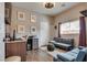 Living room with sofas, desk and mounted TV at 8736 Summoners Ct, Las Vegas, NV 89139