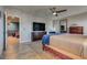 Bright primary bedroom boasting wood floors, a large dresser, and seamless access to other rooms at 8736 Summoners Ct, Las Vegas, NV 89139