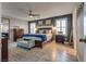 Spacious primary bedroom with wood floors, ceiling fan, accent wall and ample natural light at 8736 Summoners Ct, Las Vegas, NV 89139