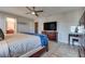 Bright primary bedroom featuring a ceiling fan, wood floors and seamless access to other rooms at 8736 Summoners Ct, Las Vegas, NV 89139
