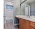 Secondary bathroom with wood-look flooring, and a white vanity at 9733 Bonanza Creek Ave, Las Vegas, NV 89148