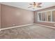 Bedroom with neutral paint, carpet flooring, and window with wood shutters at 9733 Bonanza Creek Ave, Las Vegas, NV 89148