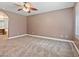 Bedroom with neutral paint, carpet flooring, ceiling fan, and window with wood shutters at 9733 Bonanza Creek Ave, Las Vegas, NV 89148