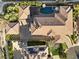 Overhead view of the home with a pool, putting green, well-maintained landscaping, and a driveway at 10000 Cresent Mesa Ln, Las Vegas, NV 89145