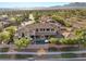 Aerial view of the backyard oasis featuring a large home, pool, mature landscaping and mountain views at 10000 Cresent Mesa Ln, Las Vegas, NV 89145