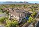 Aerial shot showcases a luxurious home with a private pool, a covered patio, and mountain views at 10000 Cresent Mesa Ln, Las Vegas, NV 89145