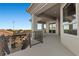 A view from the balcony overlooking the outdoor kitchen and dining area with mountain views at 10000 Cresent Mesa Ln, Las Vegas, NV 89145