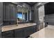 Stylish bar area features custom cabinets, marble countertops, and exterior views at 10000 Cresent Mesa Ln, Las Vegas, NV 89145