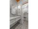 Stylish bathroom featuring a white vanity, unique wall and floor tiles, and decorative lighting at 10000 Cresent Mesa Ln, Las Vegas, NV 89145