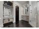 Elegant bathroom featuring dual vanities, a glass shower enclosure, and dark wood floors at 10000 Cresent Mesa Ln, Las Vegas, NV 89145