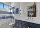 Nautical-themed bathroom with a blue vanity, subway tile, and a shower-tub combination at 10000 Cresent Mesa Ln, Las Vegas, NV 89145