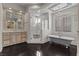 Bright bathroom features a standalone tub, glass shower, custom vanity, and decorative ceiling tile at 10000 Cresent Mesa Ln, Las Vegas, NV 89145