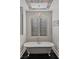 Bright bathroom with a clawfoot tub, decorative tile accents, and plantation shutters at 10000 Cresent Mesa Ln, Las Vegas, NV 89145