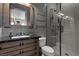 Bathroom with gray subway tile, frameless glass shower door, and dark wood vanity at 10000 Cresent Mesa Ln, Las Vegas, NV 89145