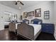 Well-lit bedroom with two beds, stylish decor, and sleek dark floors at 10000 Cresent Mesa Ln, Las Vegas, NV 89145