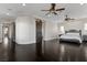 Spacious primary bedroom with dark wood floors, ceiling fans and sliding barn door at 10000 Cresent Mesa Ln, Las Vegas, NV 89145