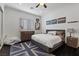 Inviting bedroom with a comfortable bed, stylish decor, and a unique area rug at 10000 Cresent Mesa Ln, Las Vegas, NV 89145