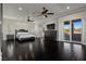 Bright primary bedroom with hardwood floors, ceiling fan, and balcony access at 10000 Cresent Mesa Ln, Las Vegas, NV 89145