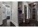 Walk-in closet with custom built-ins and glass-front cabinetry, next to the bathroom at 10000 Cresent Mesa Ln, Las Vegas, NV 89145