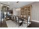 Elegant dining room featuring a large table, crystal chandelier, and custom wine storage at 10000 Cresent Mesa Ln, Las Vegas, NV 89145