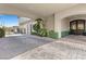 Covered driveway featuring detailed brickwork, lush greenery, and convenient access to the home's entrance at 10000 Cresent Mesa Ln, Las Vegas, NV 89145