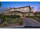 Elegant two-story home showcasing manicured landscaping and a circular driveway, perfect for curb appeal at 10000 Cresent Mesa Ln, Las Vegas, NV 89145