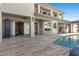 Beautiful backyard view featuring a covered patio, outdoor dining area, and a sparkling pool at 10000 Cresent Mesa Ln, Las Vegas, NV 89145