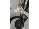 Elegant foyer showcasing a spiral staircase with iron railing and a crystal chandelier at 10000 Cresent Mesa Ln, Las Vegas, NV 89145