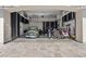 View of a well-organized garage with a classic green car, bicycles and black and white cabinetry at 10000 Cresent Mesa Ln, Las Vegas, NV 89145
