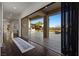 View from the hallway to the pool area through wide, folding glass doors, leading to outdoor entertainment at 10000 Cresent Mesa Ln, Las Vegas, NV 89145