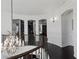 Hallway with arched entryways, decorative lighting, and dark hardwood floors at 10000 Cresent Mesa Ln, Las Vegas, NV 89145