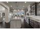 Modern kitchen with a center island, stainless steel appliances, and dark wood flooring at 10000 Cresent Mesa Ln, Las Vegas, NV 89145