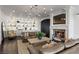 Bright living room featuring built-in shelving, a fireplace, and a comfortable leather sofa at 10000 Cresent Mesa Ln, Las Vegas, NV 89145