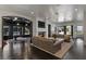 Inviting living room with a fireplace, comfortable seating, and an adjacent game room at 10000 Cresent Mesa Ln, Las Vegas, NV 89145