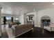 Open-concept living area with hardwood floors and views to pool and kitchen at 10000 Cresent Mesa Ln, Las Vegas, NV 89145