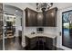 Office area with custom corner desk, dark wood cabinets, and wine cellar view at 10000 Cresent Mesa Ln, Las Vegas, NV 89145