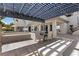 A spacious outdoor dining area with a pergola, seating, and an outdoor kitchen at 10000 Cresent Mesa Ln, Las Vegas, NV 89145