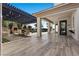A cozy outdoor dining space featuring a fireplace, bar and access to the pool and outdoor space at 10000 Cresent Mesa Ln, Las Vegas, NV 89145