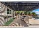 An inviting outdoor kitchen and dining area with a pergola, perfect for entertaining guests at 10000 Cresent Mesa Ln, Las Vegas, NV 89145