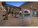 Relaxing outdoor patio and dining area with recessed lighting and view of the backyard pool at 10000 Cresent Mesa Ln, Las Vegas, NV 89145