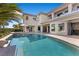 A stunning backyard featuring a sparkling pool and spa with a backdrop of a modern home at 10000 Cresent Mesa Ln, Las Vegas, NV 89145