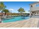 Beautiful pool with a built-in spa, lush landscaping, and an outdoor barbecue area at 10000 Cresent Mesa Ln, Las Vegas, NV 89145