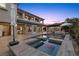 A luxurious pool and spa combination surrounded by beautiful home and dining area at 10000 Cresent Mesa Ln, Las Vegas, NV 89145