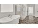 Bright bathroom featuring a soaking tub and separate glass shower at 10116 Rebel Coast St, Las Vegas, NV 89141