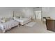 Bright bedroom featuring a large bed, walk-in closet, and neutral carpet at 10116 Rebel Coast St, Las Vegas, NV 89141