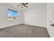 Spacious bedroom with neutral carpet, ceiling fan, and a large window providing ample natural light at 10116 Rebel Coast St, Las Vegas, NV 89141